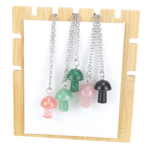Detail showing five assorted 2cm crystal mushroom pendants on silver chains