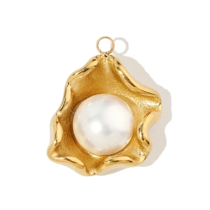 Detail view of a white pearl set in a gold shell-shaped stainless steel pendant