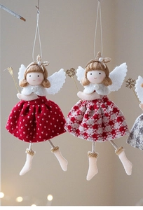Detailed view of plush angel ornament with festive red and white patterns and sequins