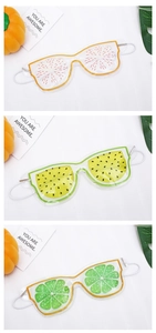 Detail view of fruit-patterned PVC sleep eye masks with cooling gel in three colors