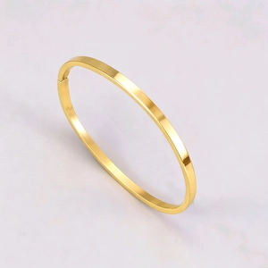 Polished gold stainless steel oval bangle featuring a minimalist mirror finish and clasp