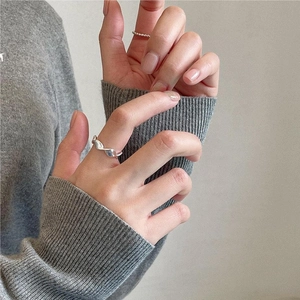 Detail of 925 sterling silver twisted mobius and beaded ring set on hand