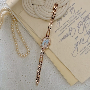 Elegant rose gold women's watch with diamond-encrusted octagonal dial and chain band