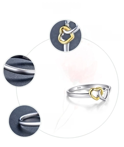 Detail of S925 sterling silver ring with interlocking 18K gold plated hearts