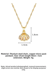 Detailed view of a gold shell pendant with zircon inlay and exact size measurements