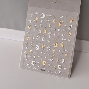 Macro shot of 3D star and moon nail stickers with gold and silver glitter details