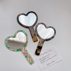 Chic heart-shaped acetate hand mirrors in tortoiseshell and floral patterns