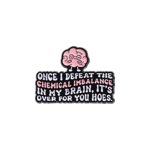 Cartoon pink brain enamel pin with glasses and quote badge on a white background