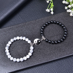 Yin Yang beaded bracelet set with white turquoise and black matte stone on leather background