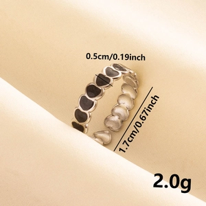 Detailed view of silver stainless steel ring with black enamel heart motifs and dimensions