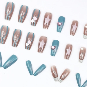 Long ballerina press-on nails featuring blue star patterns and 3D heart rhinestones