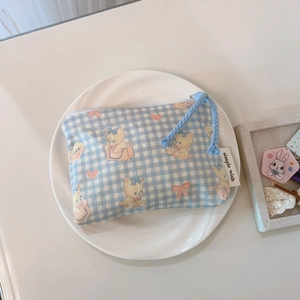 Detail of blue plaid canvas mini pouch with cartoon bear and blue braided zipper cord