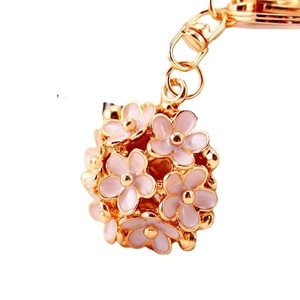 Golden keychain with a 3D hollow pink enamel daisy flower ball pendant accessory