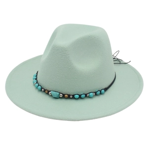 Detail of mint green fedora hat featuring ethnic turquoise beaded band decoration