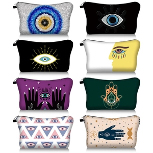 Detailed grid view showing eight varied Evil Eye and Hamsa printed travel makeup bags