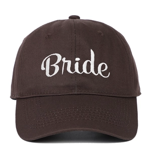 Close-up of white Bride embroidery on a brown cotton twill baseball cap with stitching