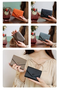 Litchi pattern leather wallets in orange, black, and grey showing envelope snap closure