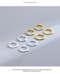 Detail of S925 sterling silver hoop earrings with micro-pave crystals and a small hanging loop