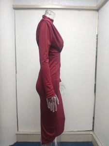 Detail of burgundy long sleeve fitted dress with waist pleats and high neckline design