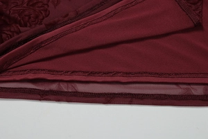Detail of burgundy rose jacquard lace dress hem with professional double stitching