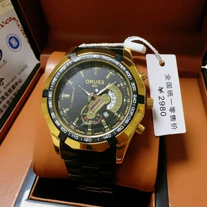 Detailed view of ORUSS 1853 black and gold chronograph watch with metal band and box