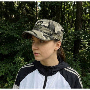 Detail of embroidered army patch and camo pattern on a flat top tactical cap
