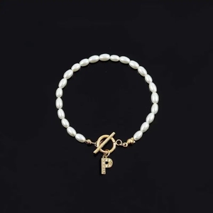 Elegant white oval pearl bracelet with a golden T-bar clasp and rhinestone letter P charm