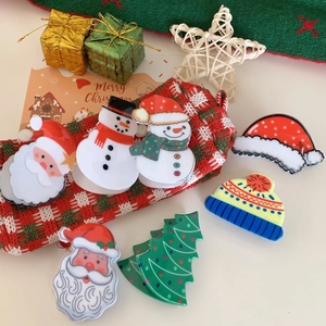 Christmas hair claw clips set featuring Santa, snowman and tree on white background