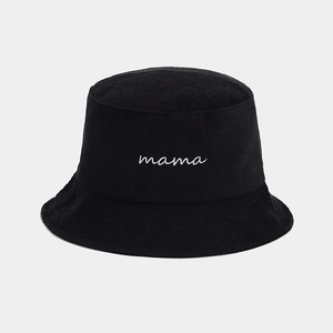 Dettaglio ravvicinato del ricamo mama bianco su un cappello a secchiello nero