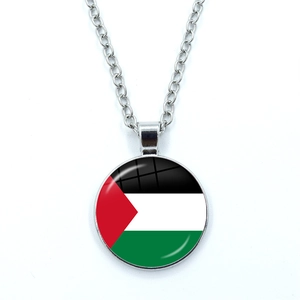 Detailed view of Palestine flag pendant with round glass gem and silver chain