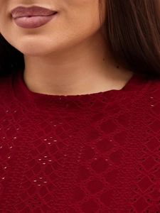 Close-up of deep red hollow lace short sleeve top with intricate eyelet embroidery detail