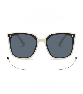 Detail of cream white oversized square sunglasses with silver metal temple accents