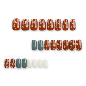 Solid color press-on nails set featuring brick red hearts, forest green and white glossy finish