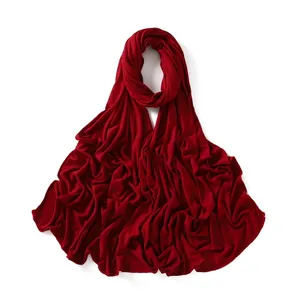 Detail of burgundy jersey cotton scarf showing soft fabric texture and stitched edges
