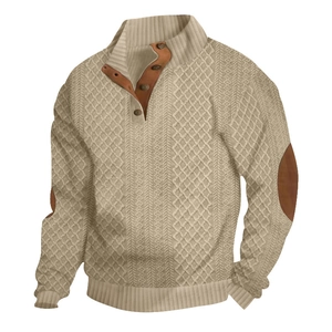 Detail of cable knit pattern with leather button placket and elbow patches on beige sweater