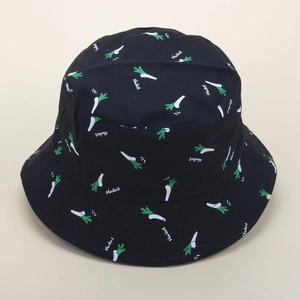 Detail of black cotton bucket hat featuring green shallot prints and typography patterns