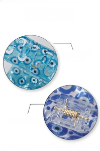 Detail view of smooth hair claw clip teeth and strong metal spring with evil eye print