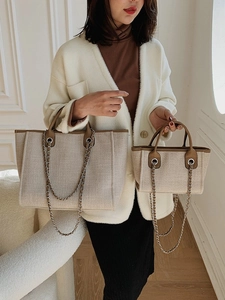 Minimalist canvas tote bag with leather trim and silver chain strap in two sizes