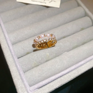 Detail view of double-layer gold ring with pink pearl and micro-paved cubic zirconia