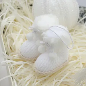Mini white knitted Christmas boot ornaments with faux fur trim for holiday tree decor