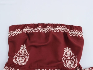 Detailed view of bohemian floral print and elastic pleated neckline on wine red tube dress
