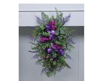 Close-up of purple lavender and pink flower clusters on a green hanging wreath decoration