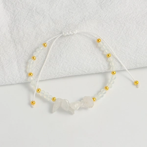 Detail of adjustable handmade bohemian bracelet with faceted white beads and clear crystals