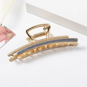 Elegant gold metal hair claw clip with grey accents for women minimalist summer hair style
