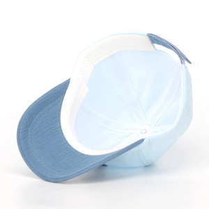 Detail of baby baseball cap featuring cotton sweatband and adjustable velcro strap closure