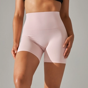 Close-up of high-waisted pale pink yoga shorts with elastic fit and seamless texture