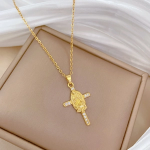 Macro detail of gold cross necklace with Our Lady of Guadalupe and sparkling crystals