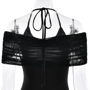 Detail view of black off-shoulder dress featuring mesh splicing and halter neck design