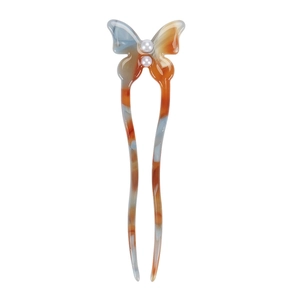 Detail of butterfly hair pin with orange and blue marble resin texture and pearls