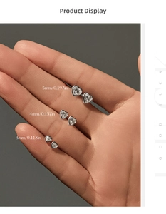 Three sizes of heart-cut moissanite silver studs held to show scale (3mm, 4mm, 5mm)